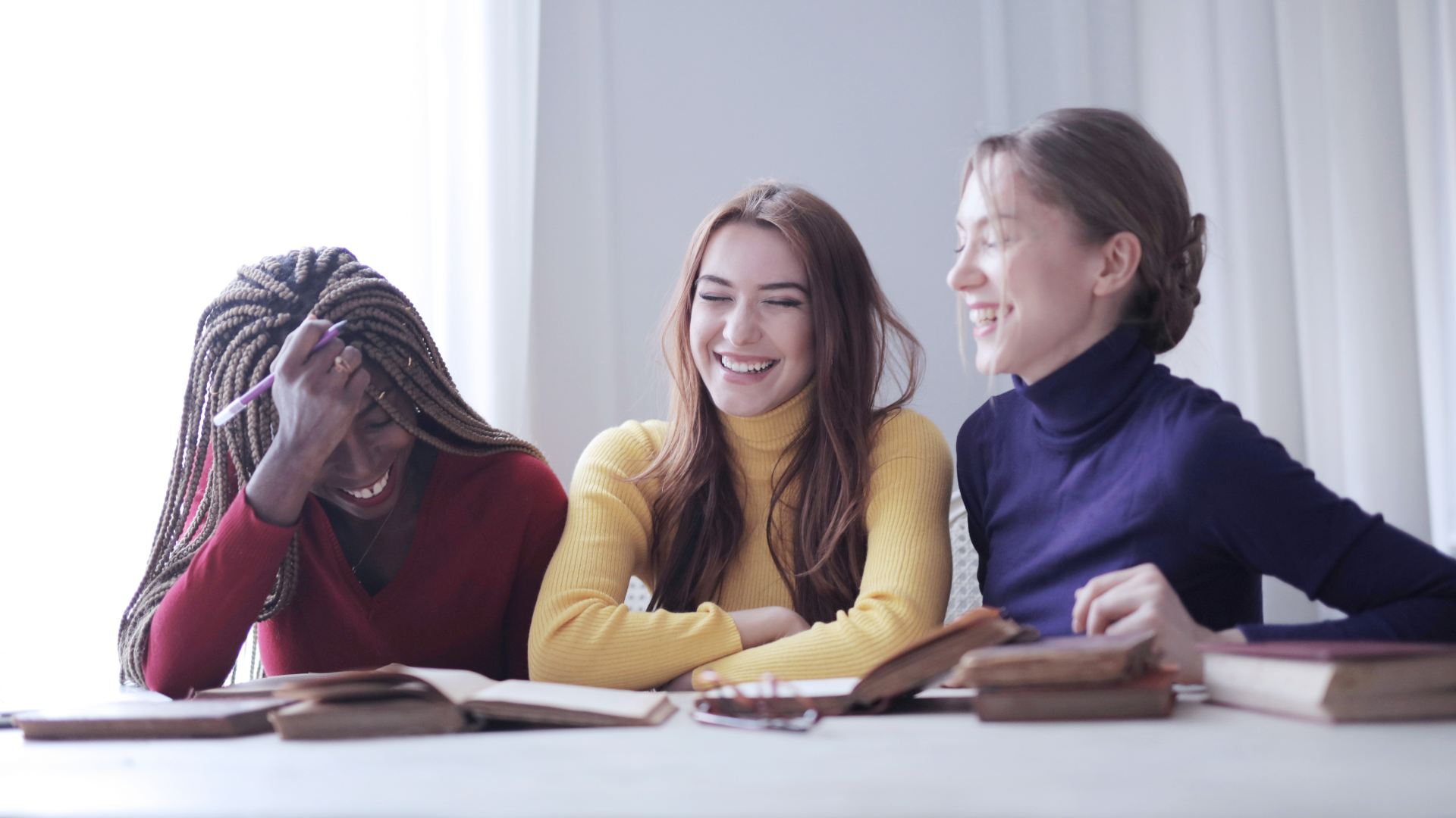 Women sitting at a table and laughing